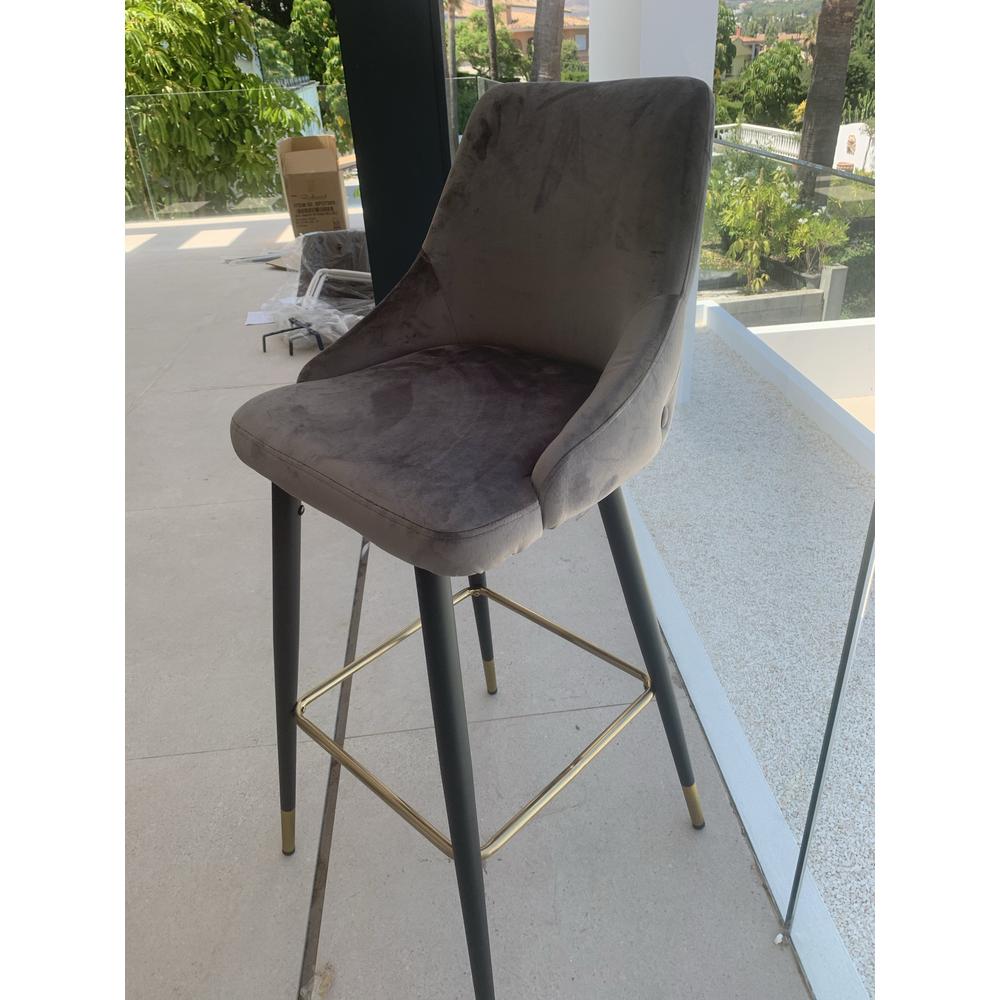 Airmani khaki velvet bar stool with black legs and gold footrest.