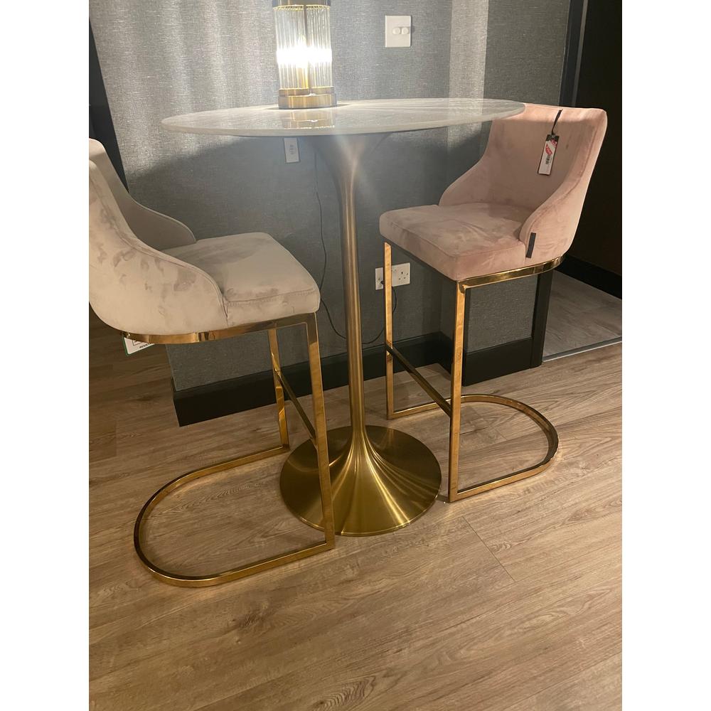 Two Bolton K Velvet Counter bar stools, one pink, one stone, with gold frames and a matching round bar table.