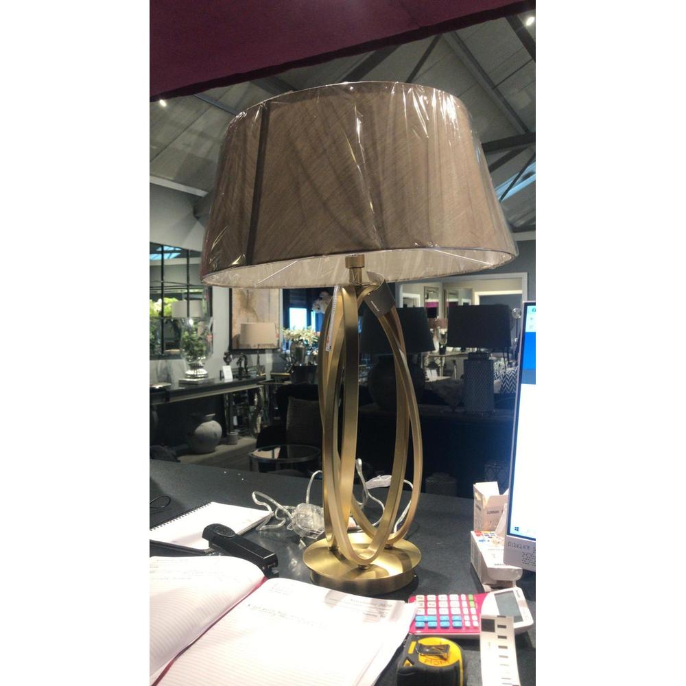 Brisa antiqued brass table lamp with a unique looped metal base and dark fabric shade.