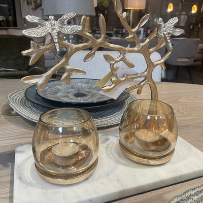 Butterfly gold candle holder on marble slab