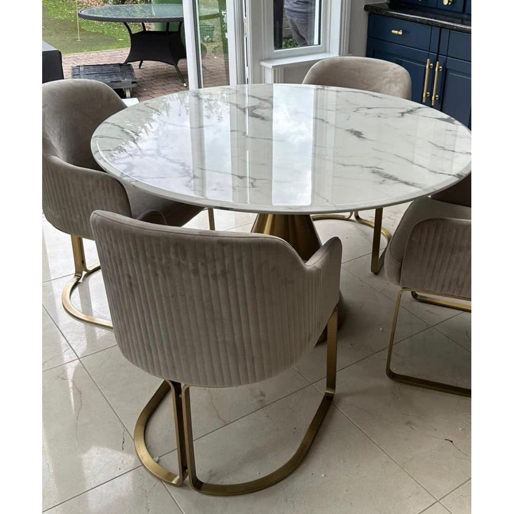 Camden Club designer dining chair with stone velvet upholstery and brushed gold frame, paired with a round marble table.