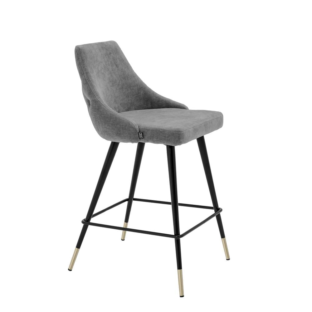 Cedro Stool by Eichholtz: Grey upholstered bar stool with black tapered legs and gold tips.