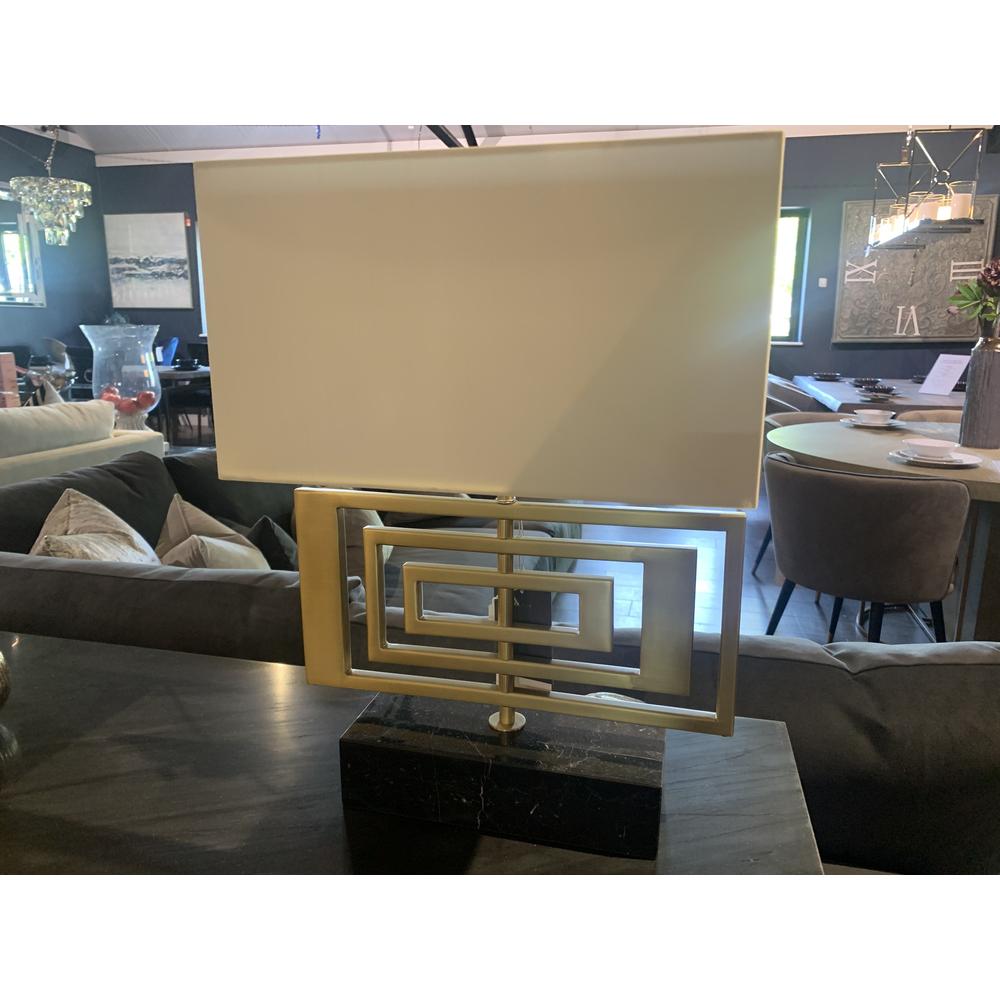 Derry table lamp with rectangular cream shade, antique brass geometric base, and black marble plinth.