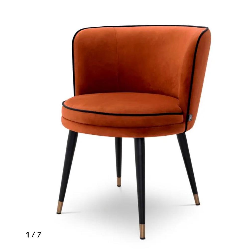 Grenada luxury swivel dining chair by Eichholtz, in orange velvet with black piping and black & brass legs.