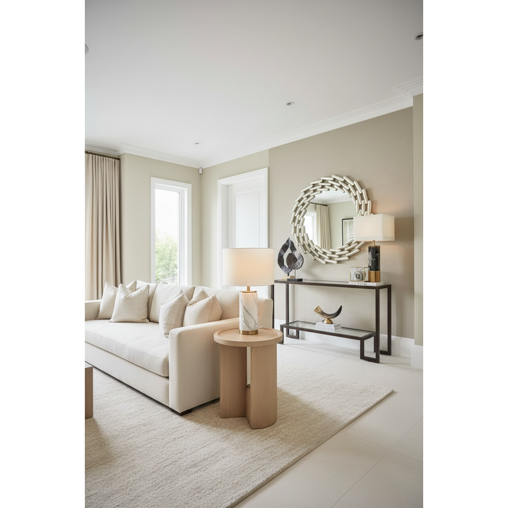 Large round silver leaf link mirror with a unique geometric frame, displayed above a console table.