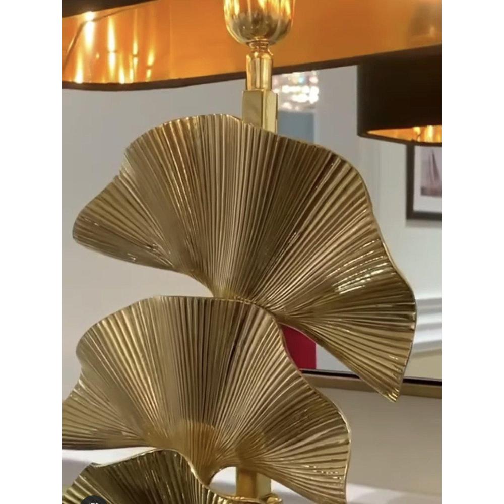 Olivier table lamp with polished brass palm leaves, black granite base, and black velvet shade.