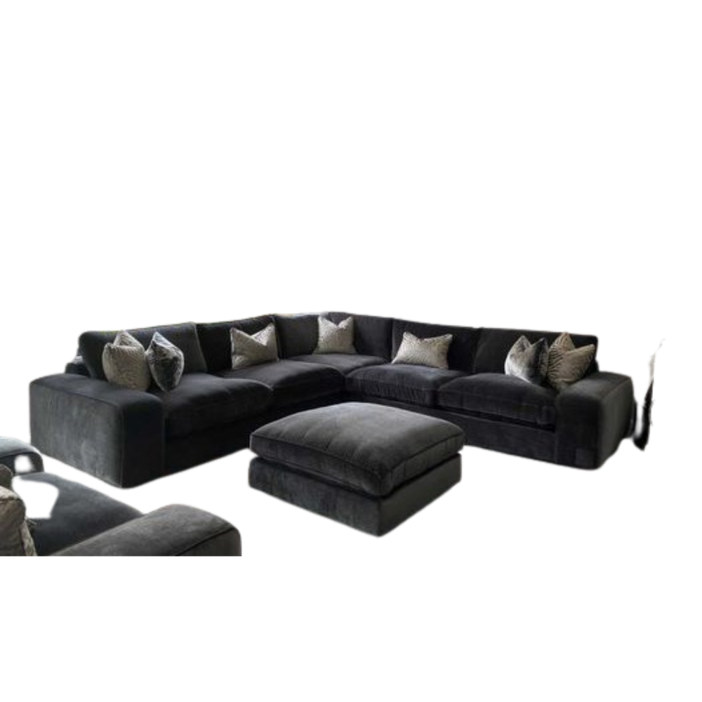Dark grey oversized Solace Cinema Sofa sectional with matching footstool and decorative cushions.