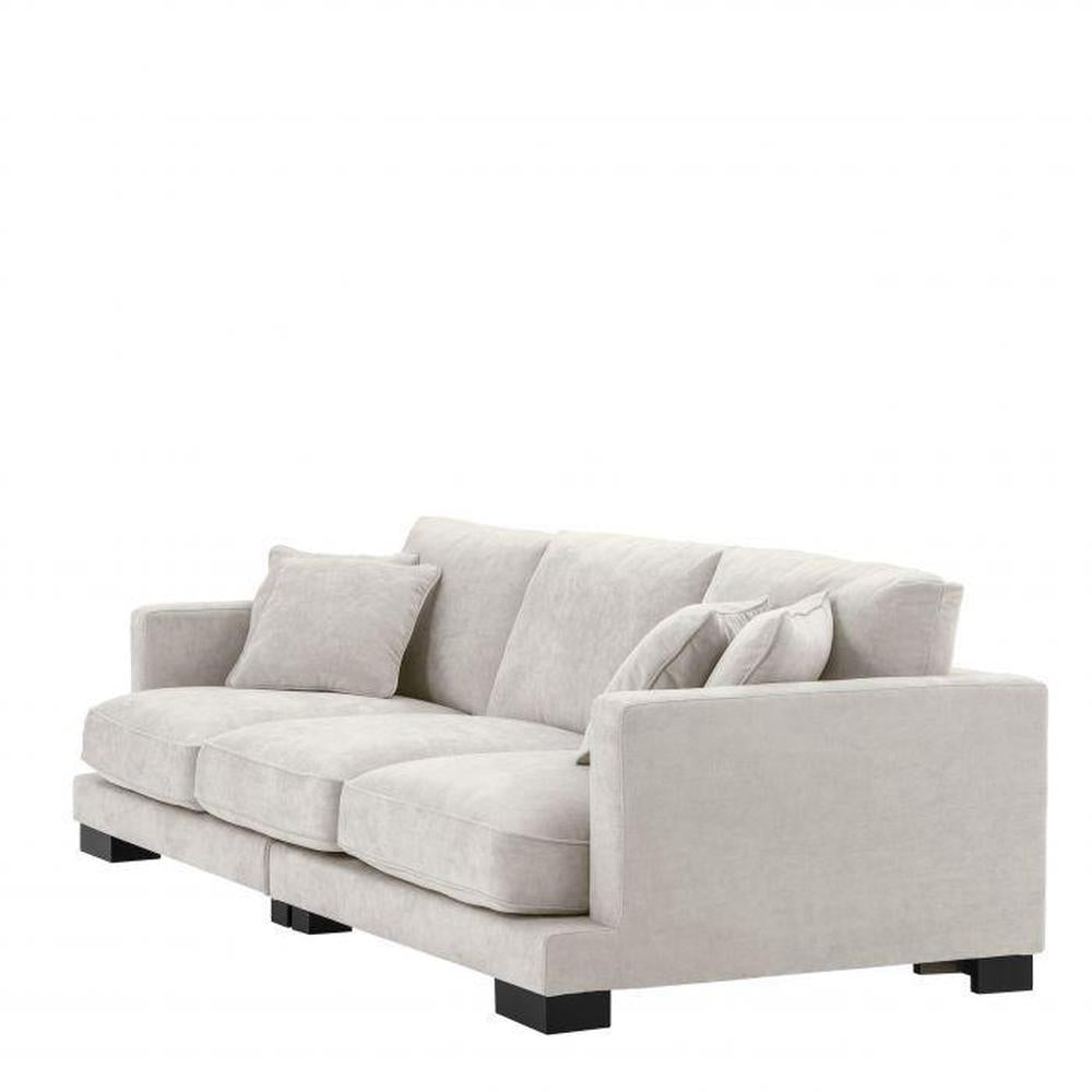 Tuscany XL designer sofa by Eichholtz in light sand fabric with black feet.