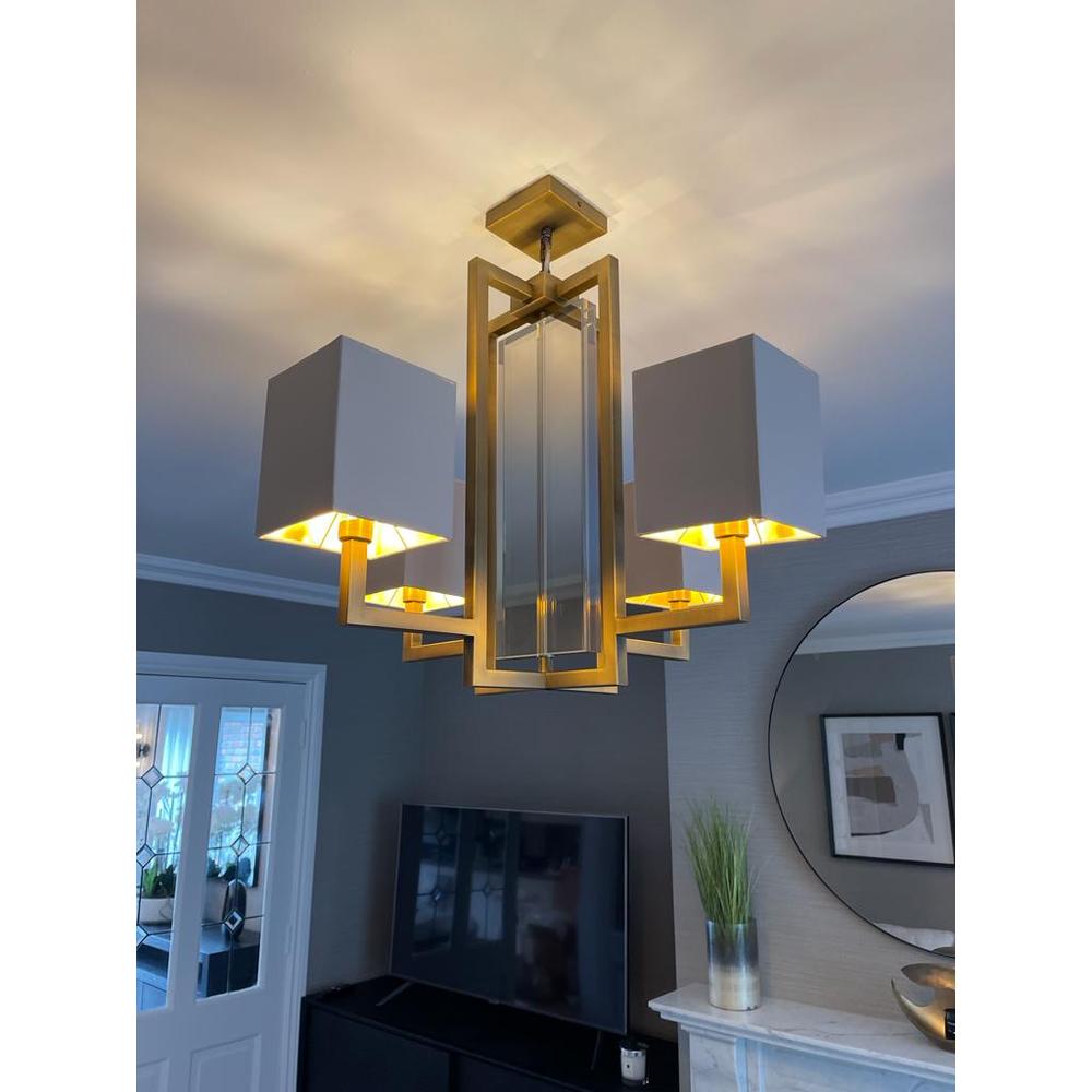 Blea antique brass finish chandelier with four cream fabric shades and cognac crystal accents.