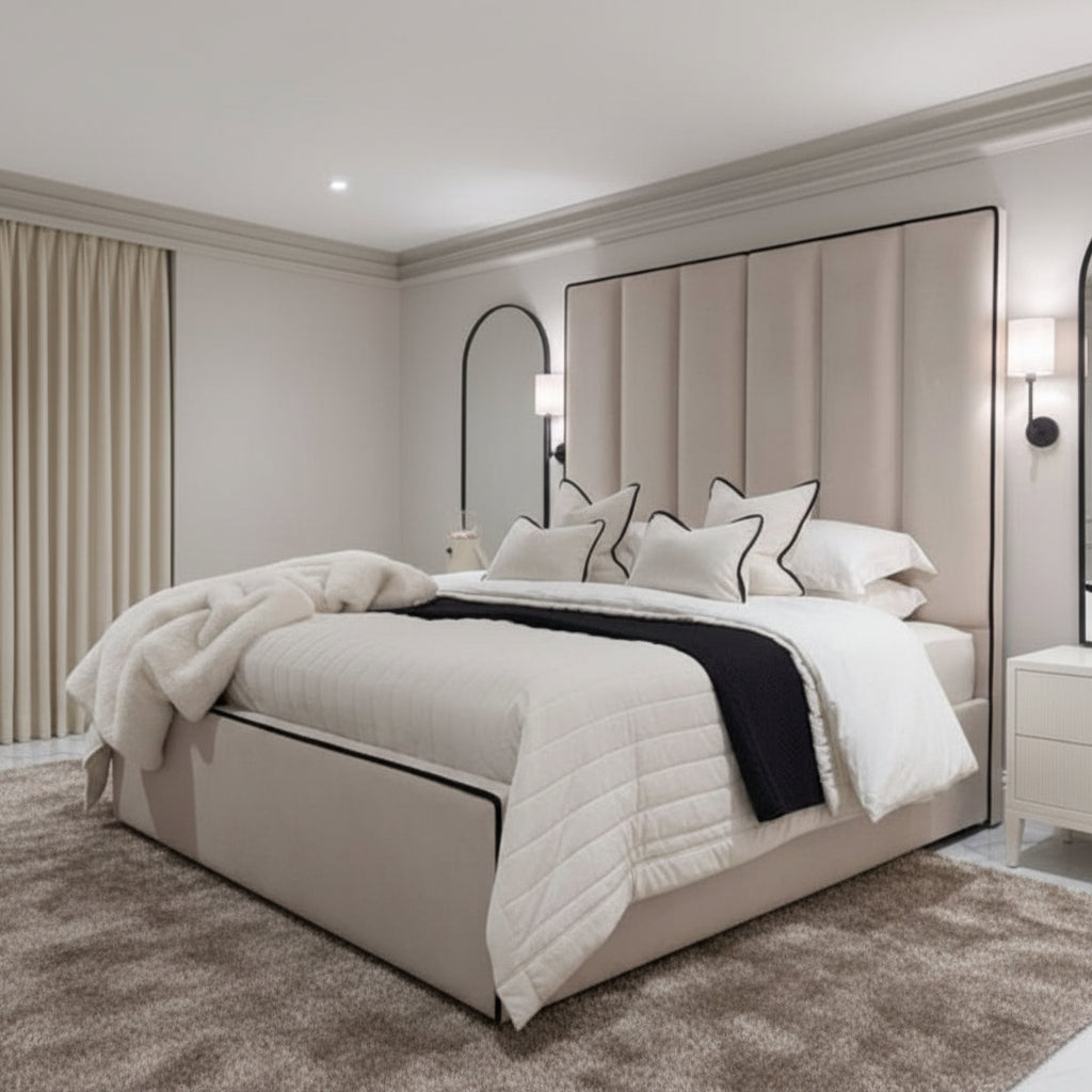 Custom Belle bed frame with super high upholstered panel headboard in beige, with white bedding and nightstands