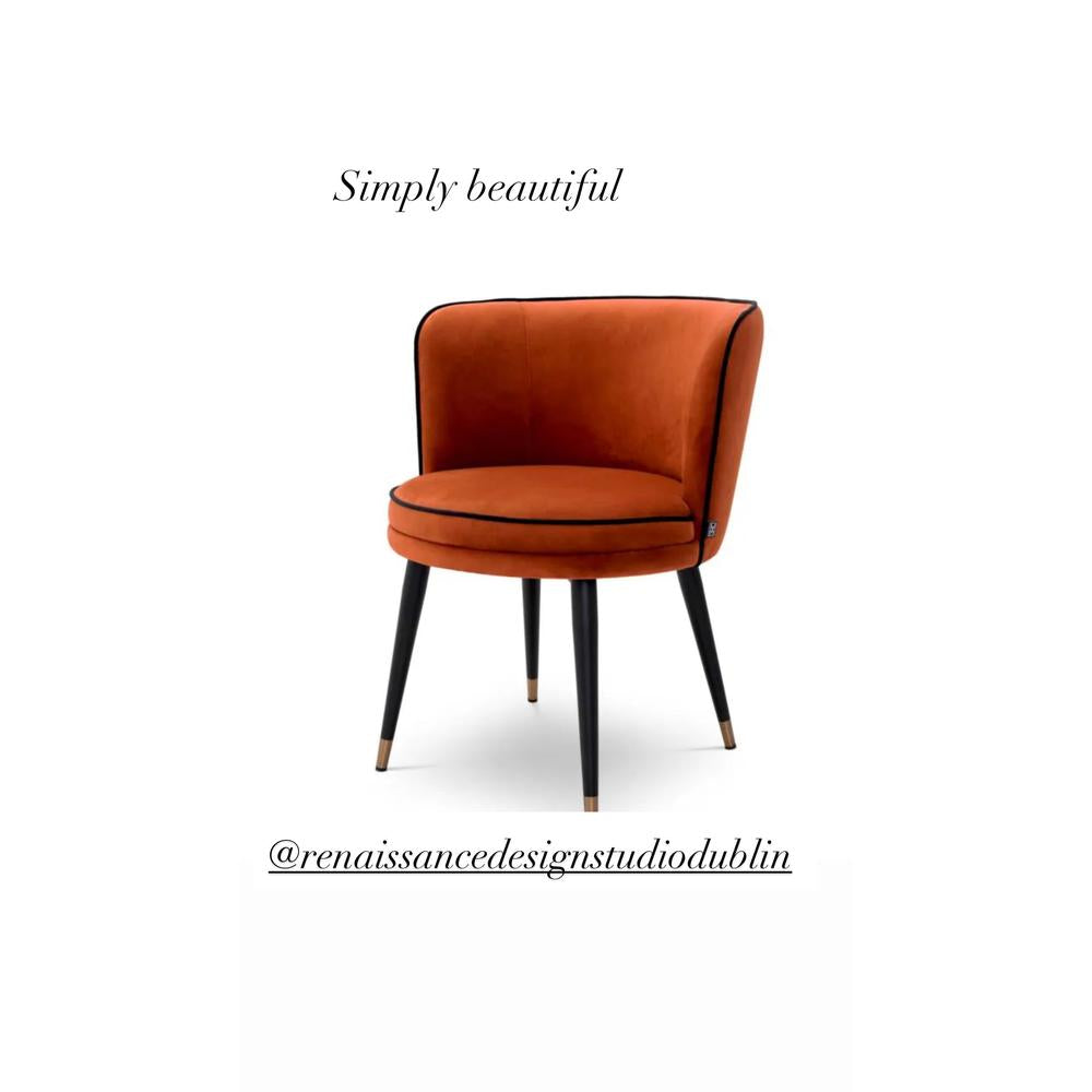 Grenada luxury swivel dining chair by Eichholtz, in orange velvet with black piping and black & brass legs.