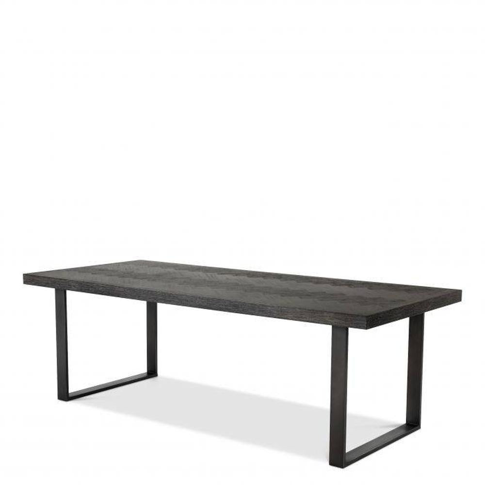 Melchior large designer dining table with charcoal oak veneer top and bronze finish U-shaped legs.