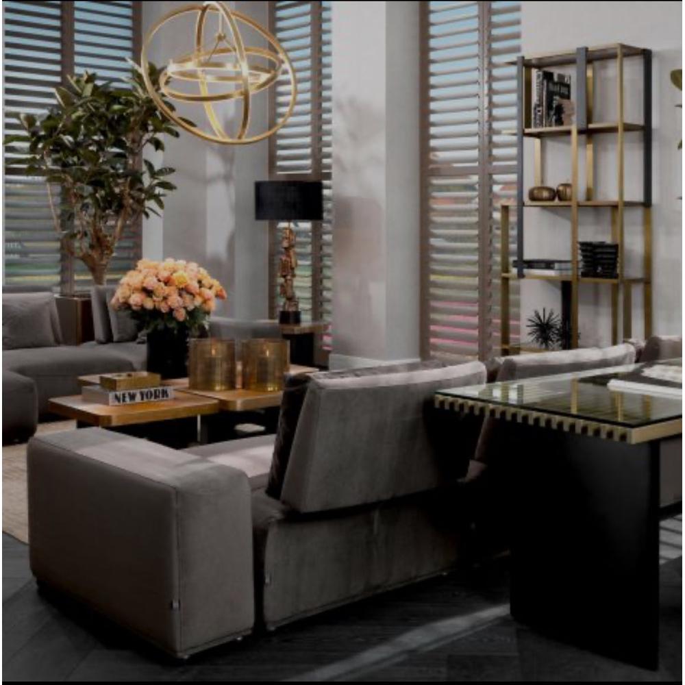 Eichholtz Mondial modular sofa in granite grey polyester, with chaise, in a modern living room.