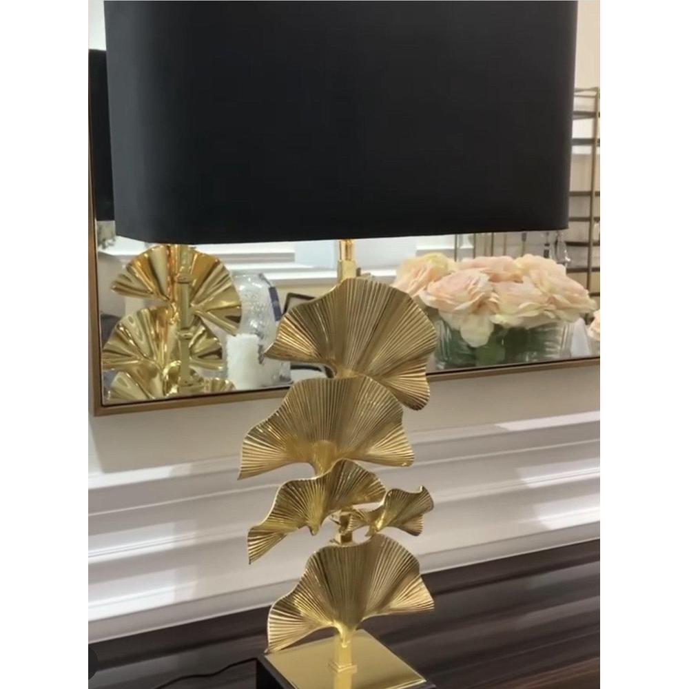 Olivier table lamp with polished brass palm leaves, black velvet shade, and black granite base.
