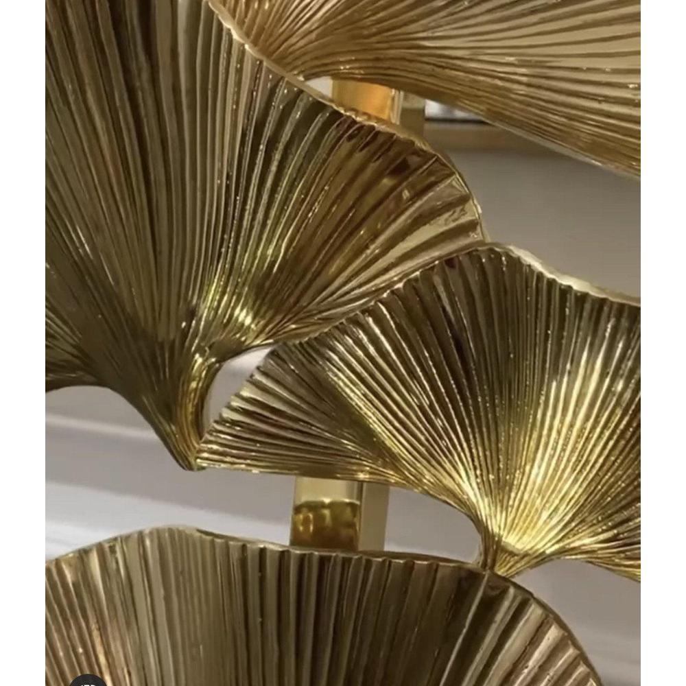 Close-up of Olivier table lamp with polished brass palm leaves and black velvet shade.