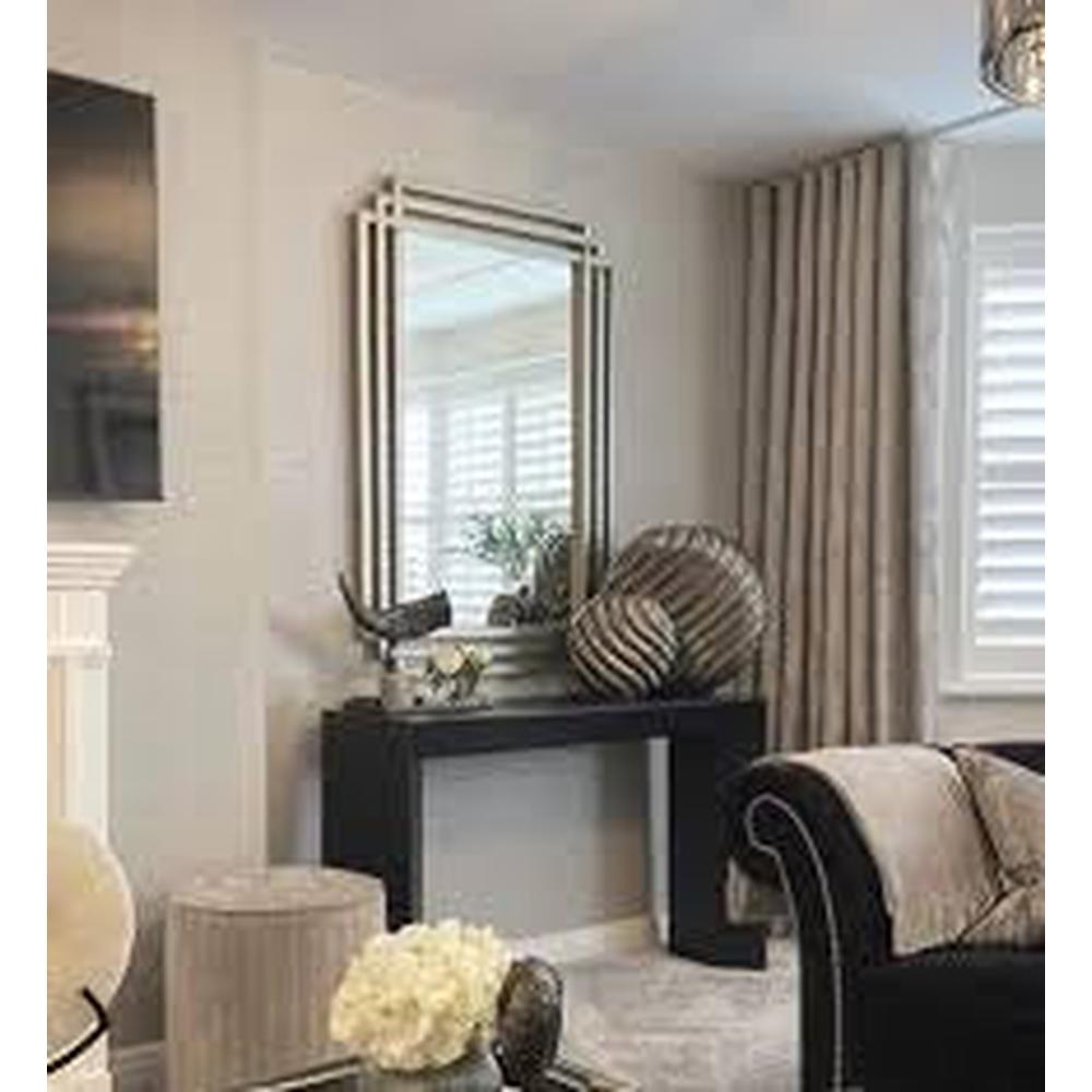 Oswin Triple Framed Mirror by RV ASTLEY, a champagne silver leaf mirror with a geometric frame, above a black console table.