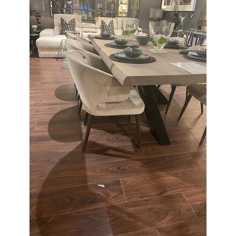 Renaissance Contemporary Chelsea Dining Chair in Quartz Khaki fabric with black beech legs, beside a wooden table.