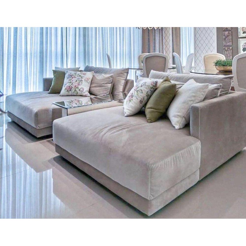 Two luxurious Riberio Milano chaise sofas in light beige fabric with decorative throw pillows.
